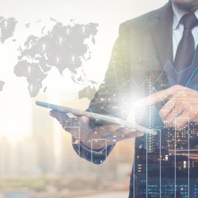 Double exposure of businessman using the tablet with cityscape a