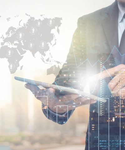 Double exposure of businessman using the tablet with cityscape a